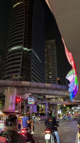 Bangkok traffic stops at red light near modern building