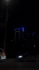 Nighttime skyscrapers filmed from moving vehicle in Krasnodar