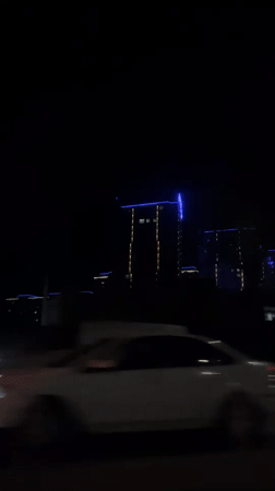Nighttime skyscrapers filmed from moving vehicle in Krasnodar
