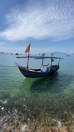 Fishing boats and palm-fringed calm at Nha Trang Bay