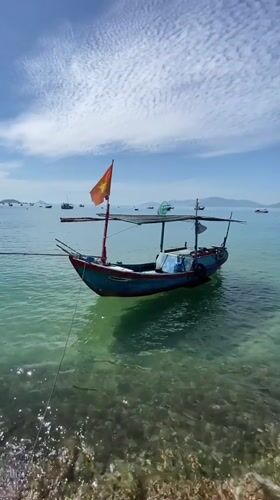 Fishing boats and palm-fringed calm at Nha Trang Bay