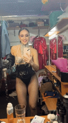 Showgirl prepares in dressing room mirror, Kazan evening