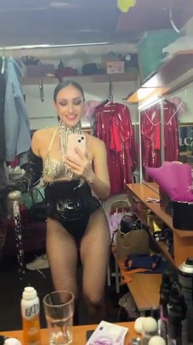 Showgirl prepares in dressing room mirror, Kazan evening