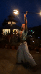 Street performers draw crowds near illuminated temple in Haini