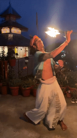 Street performers draw crowds near illuminated temple in Haini
