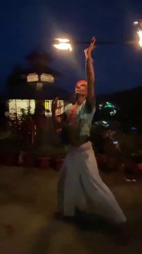 Street performers draw crowds near illuminated temple in Haini