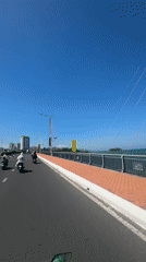 Morning motorcycle ride captured crossing bridge in Nha Trang