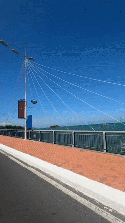 Morning motorcycle ride captured crossing bridge in Nha Trang