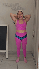 Woman in pink workout clothes observed in Puebla room