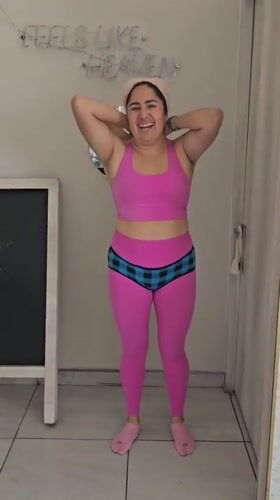 Woman in pink workout clothes observed in Puebla room
