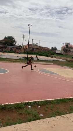Basketball game played on outdoor court in Gura Top