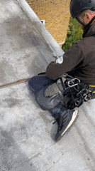 Worker performs routine rooftop maintenance in London