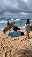 Early morning surfing session continues despite stormy skies