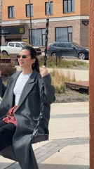 Woman enjoys swing set moment in sunny Krasnoyarsk morning