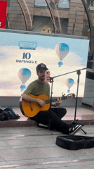 Street musician, waterfront dining captured in afternoon Yerevan scenes