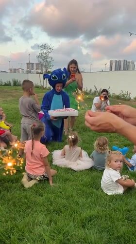 Stitch costume, sparklers, and kids at a backyard birthday party