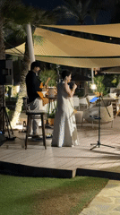 Live duo performance on an outdoor stage in Estepona at night