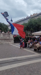 French flag display, costumed figure spotted in Budapest square