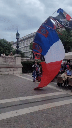 French flag display, costumed figure spotted in Budapest square