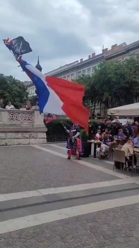 French flag display, costumed figure spotted in Budapest square