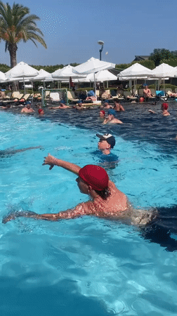 Water polo and swimming at a sunny resort pool in Aksu
