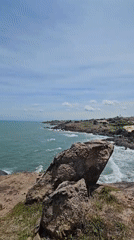 Morning at Mui Ne's rocky coastline, waves and rock cairns
