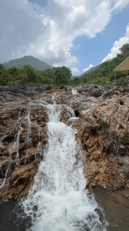 Tourists visit waterfall swimming spot in Khanh Vinh Vietnam
