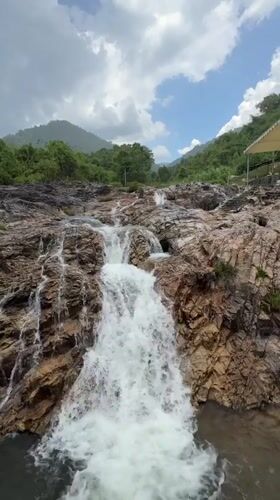 Tourists visit waterfall swimming spot in Khanh Vinh Vietnam