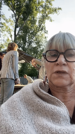 Evening outdoor dining scene captured in Veauchette, France
