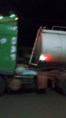 Mixed vehicle traffic on dark streets late at night