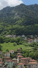 Mountain village with red-roofed houses captured in scenic valley