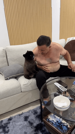 Man shares late-night meal with small dog in Thailand home