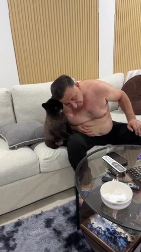 Man shares late-night meal with small dog in Thailand home
