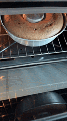 Home baker checks chocolate ring cake progress in Mexican kitchen