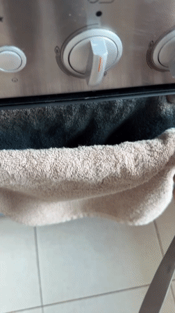 Home baker checks chocolate ring cake progress in Mexican kitchen