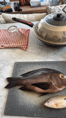 Fresh whole fish laid out on a cutting board in Bali