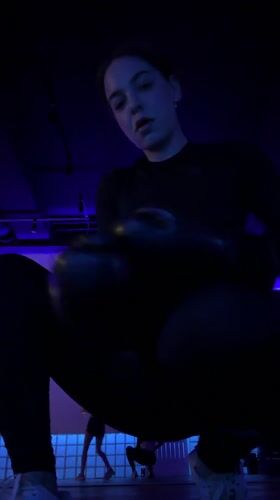 Woman in boxing gloves poses during workout session in Moscow gym