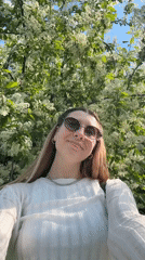 Woman photographs spring blossoms near Moscow church