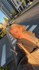 Woman takes selfies around Belgrade during golden hour