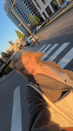 Woman takes selfies around Belgrade during golden hour