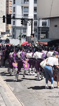 Children in traditional costumes parade through La Paz streets