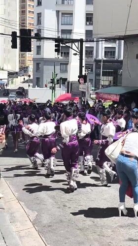 Children in traditional costumes parade through La Paz streets