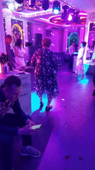 Late-night party scene under purple lights in Komsomolsk-on-Amur