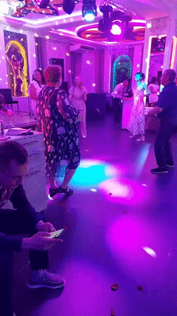 Late-night party scene under purple lights in Komsomolsk-on-Amur