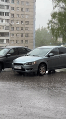 Rainy parking scene and elevator activity captured simultaneously