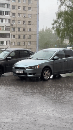 Rainy parking scene and elevator activity captured simultaneously