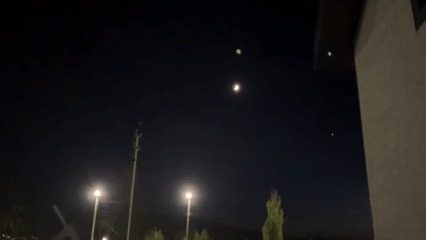 Evening snapshots capture mundane nighttime scenes with lights and moon