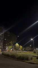 Nighttime street scene with crescent moon captured in Buenos Aires