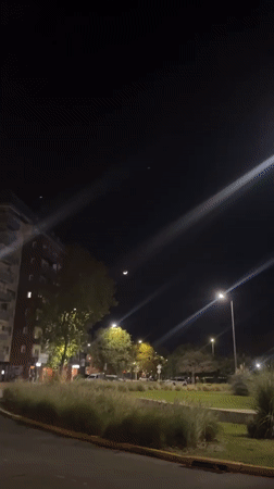 Nighttime street scene with crescent moon captured in Buenos Aires