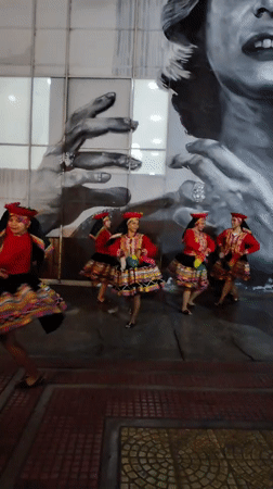 Traditional folk dancers and musicians perform outdoors in Barranco
